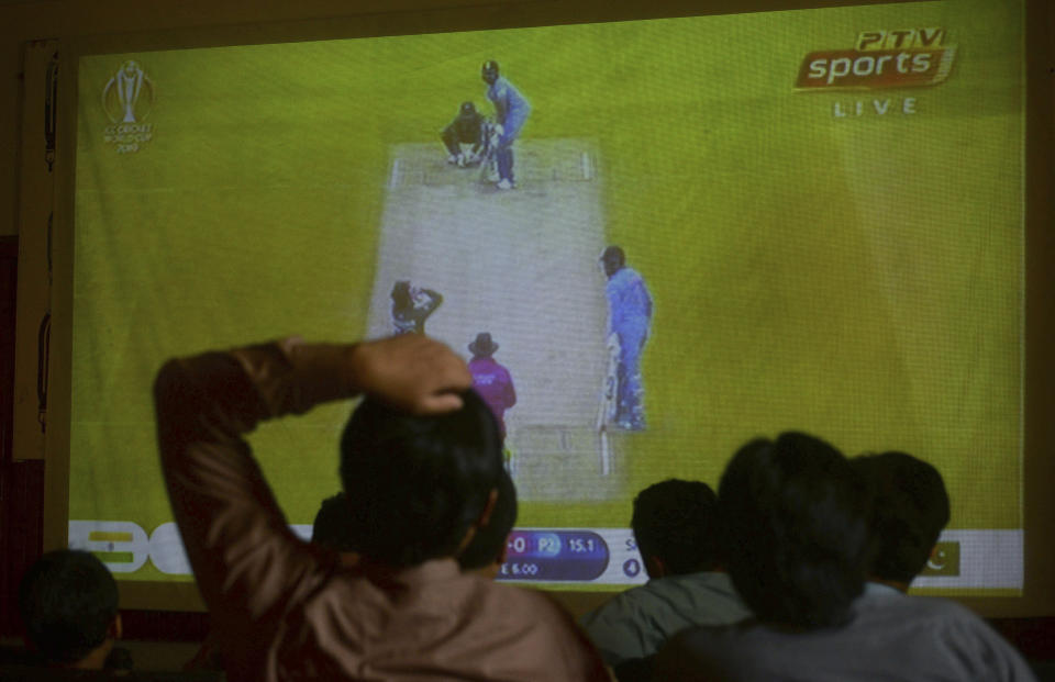 People watch the cricket World Cup match between Pakistan and India, on a big screen in Peshawar, Pakistan, Sunday, June 16, 2019. (AP Photo/Mohammad Sajjad)