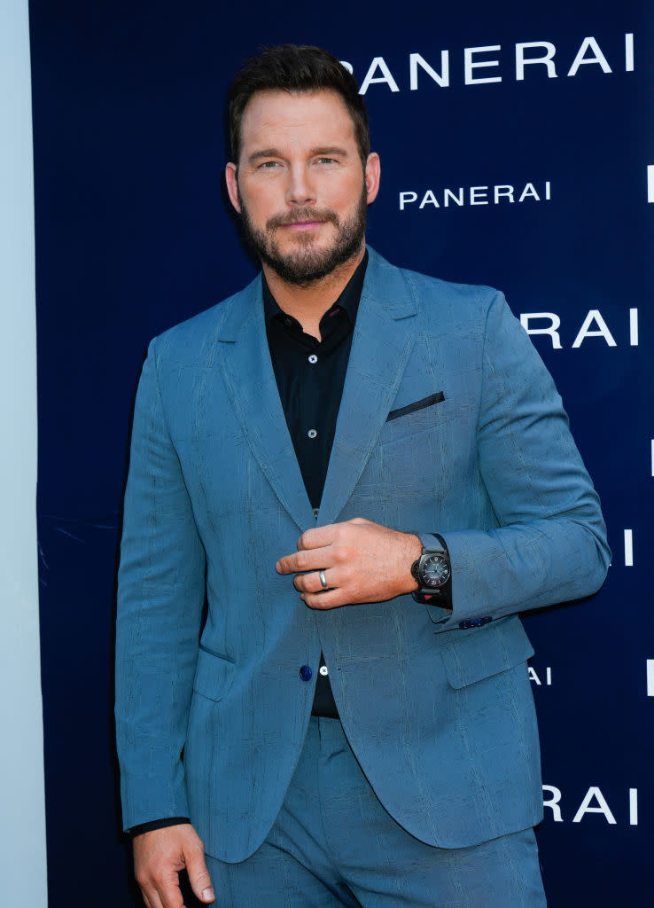 Close-up of Chris in a suit at a media event