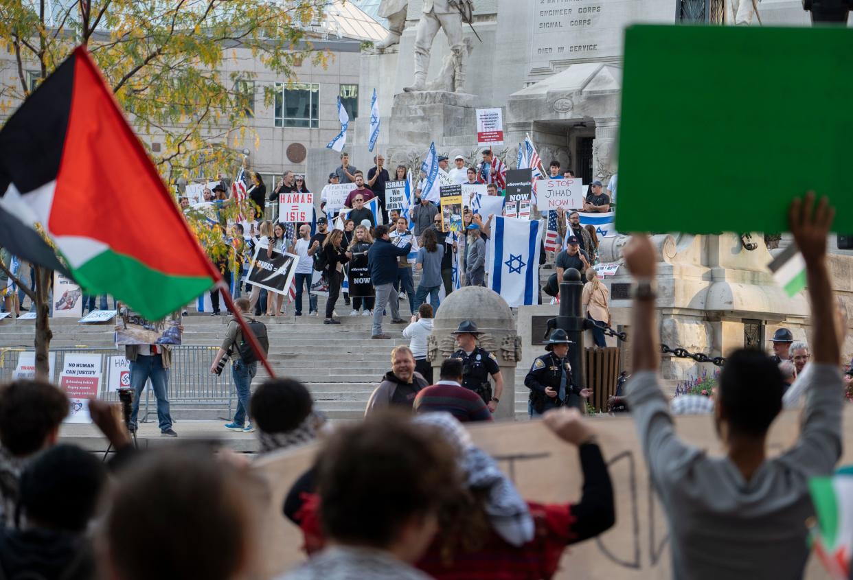 Dozens of pro-Israel counter-demonstrators stand on the steps of the Soldiers & Sailors Monument during a pro-Palestinian rally held Thursday on Monument Circle in Indianapolis.
