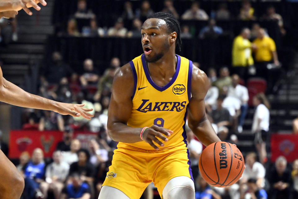 Los Angeles Laker guard Bronny James Jr. handles the ball during the first half of an NBA summer league basketball game against the Houston Rockets Friday, July 12, 2024, in Las Vegas. (AP Photo/David Becker)