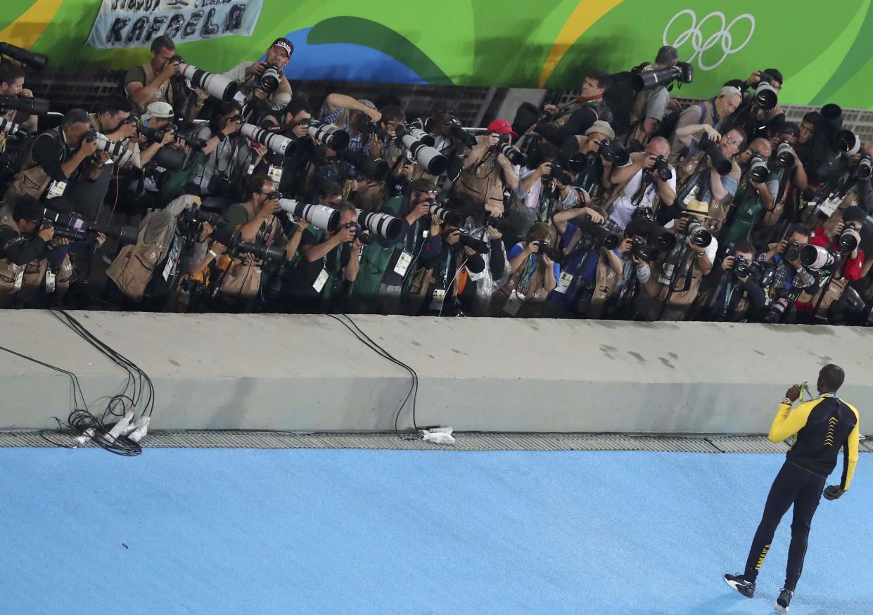 Sprint great Usain Bolt poses for an army of photographers after winning the 100m race at the 2016 Rio de Janeiro Olympics.