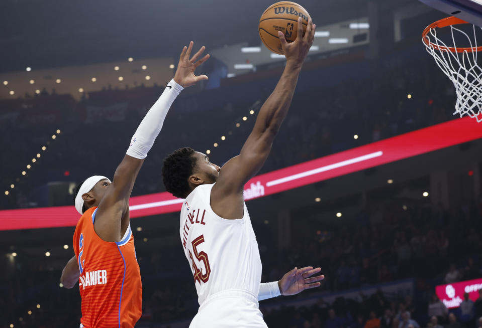 Nov 8, 2023; Oklahoma City, Oklahoma, USA; Cleveland Cavaliers guard Donovan Mitchell (45) shoots in front of Oklahoma City Thunder guard Shai Gilgeous-Alexander (2) during the first quarter at Paycom Center. Mandatory Credit: Alonzo Adams-USA TODAY Sports