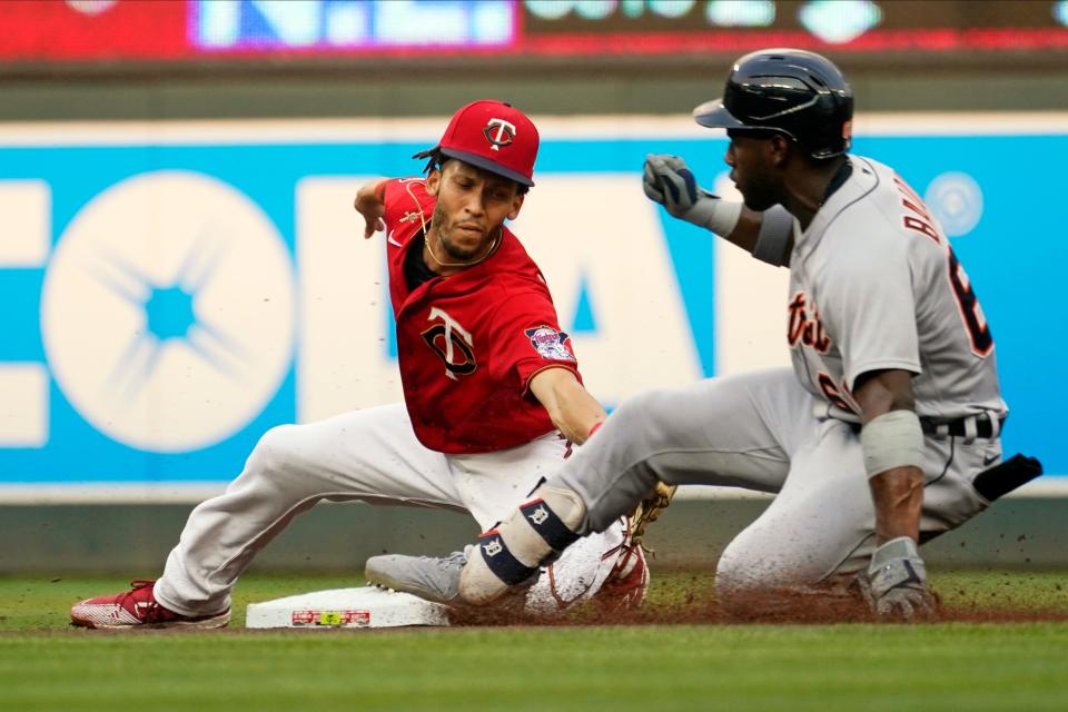 Detroit Tigers' Akil Baddoo, right, beats the tag by Minnesota Twins shortstop Andrelton Simmons for a double during the first inning of a baseball game, Tuesday, July 27, 2021, in Minneapolis.