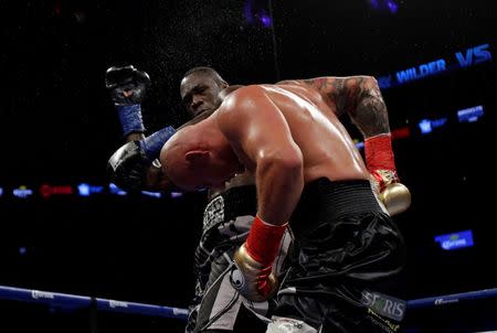 Jan 16, 2016; Brooklyn, NY, USA; Deontay Wilder (black and white shorts) and Artur Szpilka (black shorts) box during their heavyweight title boxing fight at Barclays Center. Wilder defeated Szpilka via ninth round knockout. Mandatory Credit: Adam Hunger-USA TODAY Sports