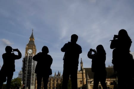 Tourists take photographs of the Elizabeth Tower, commonly known as Big Ben in London, Britain