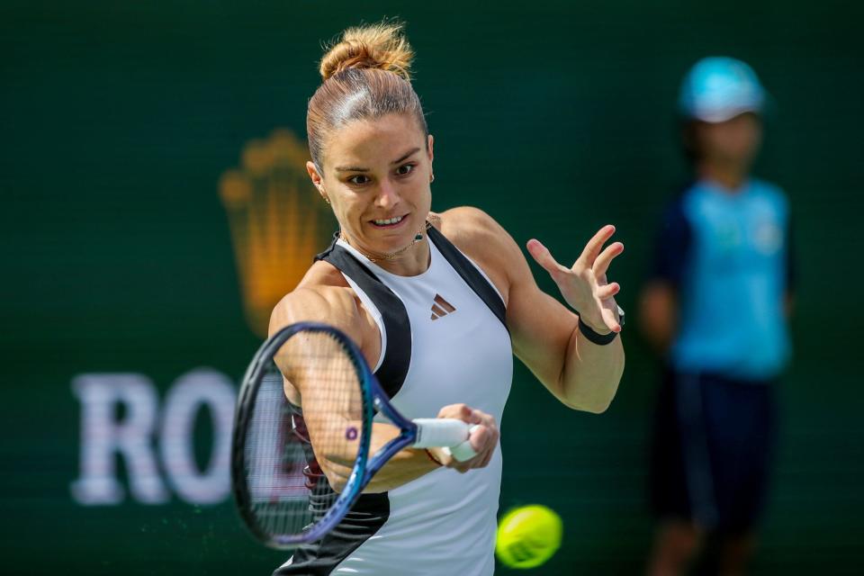 Maria Sakkari returns to Iga Swiatek during their BNP Paribas championship match at the Indian Wells Tennis Garden in Indian Wells, Calif., on Sunday, March 17, 2024.