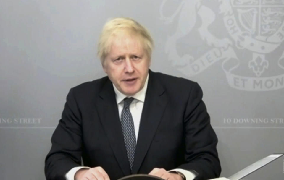 In this grab taken from video, Britain's Prime Minister Boris Johnson gives a statement on the defence review via video link from 10 Downing Street, in London, Thursday, Nov. 19, 2020. Johnson has backed what is being touted as the biggest investment program in the U.K.'s armed forces since the end of the Cold War three decades ago. Johnson told lawmakers Thursday that the four-year financial package for the Ministry of Defense will “end the era of retreat” and pivot ting it towards potential future threats. Johnson said the armed forces will receive an additional 16.5 billion pounds ($21 billion) over and above the government’s earlier plans. (House of Commons/PA via AP)