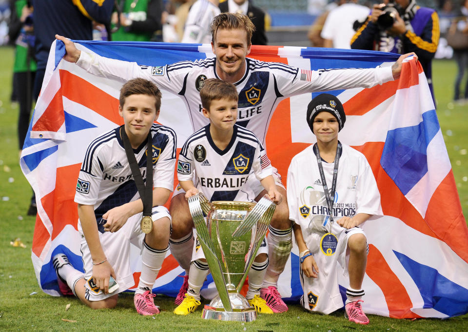 **Embargoed until 0001 May 2, 2020** File photo dated 02-12-2012 of LA Galaxy's David Beckham poses his sons (left to right) Brooklyn, Cruz and Romeo after winning the MLS Cup Final at the Home Depot Center, Los Angeles, USA.