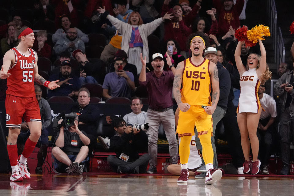 Southern California forward DJ Rodman, right, celebrates after scoring with seconds left, as Utah guard Gabe Madsen reacts during the second half of an NCAA college basketball game Thursday, Feb. 15, 2024, in Los Angeles. (AP Photo/Mark J. Terrill)