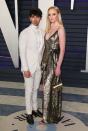 <p>Joe wears an all-white tuxedo while Sophie’s in a metallic wrap dress. <em>[Photo: Getty]</em> </p>