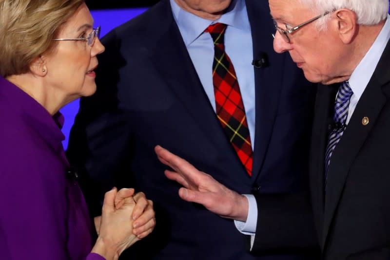 FILE PHOTO: Democratic 2020 U.S. presidential candidates Senator Elizabeth Warren speaks with Senator Bernie Sanders after the seventh Democratic 2020 presidential debate at Drake University in Des Moines