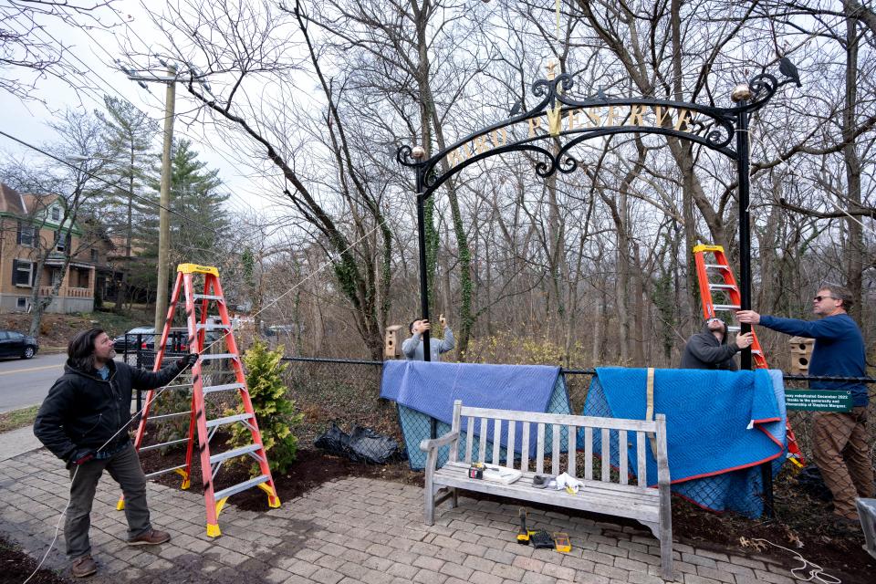Stephen Mergner, a Clifton resident, helps install a rescued 100-year-old arch with Cincinnati Park workers on Dec. 9, 2022. Mergner rescued the arch from a ravine three years ago and restored it on his time and dime.