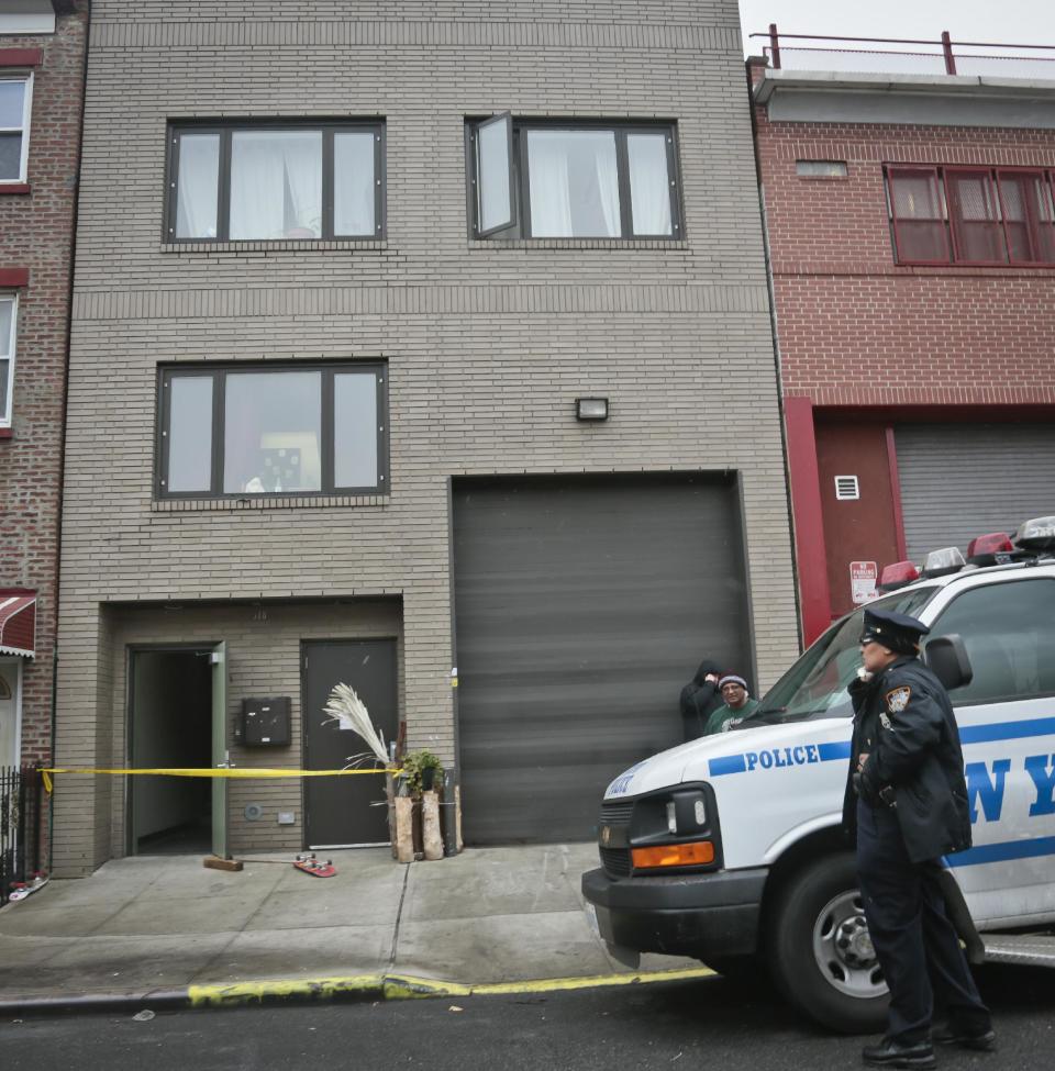 A police vehicle parks outside the location of a Monday shooting rampage, Tuesday, Nov. 12, 2013 in Brooklyn, New York. Police said gunman Ali Akbar Mahammadi Rafie, 29, a musician, killed himself on the roof after shooting to death two members of the Iranian indie rock band Yellow Dogs, a third musician and wounding a fourth person early Monday morning. The shooter was a member of another band from Iran, the Free Keys, who knew the victims but hadn't spoken to them in months because of a "petty conflict," according to Yellow Dogs manger Ali Salehezadeh. (AP Photo/Bebeto Matthews)