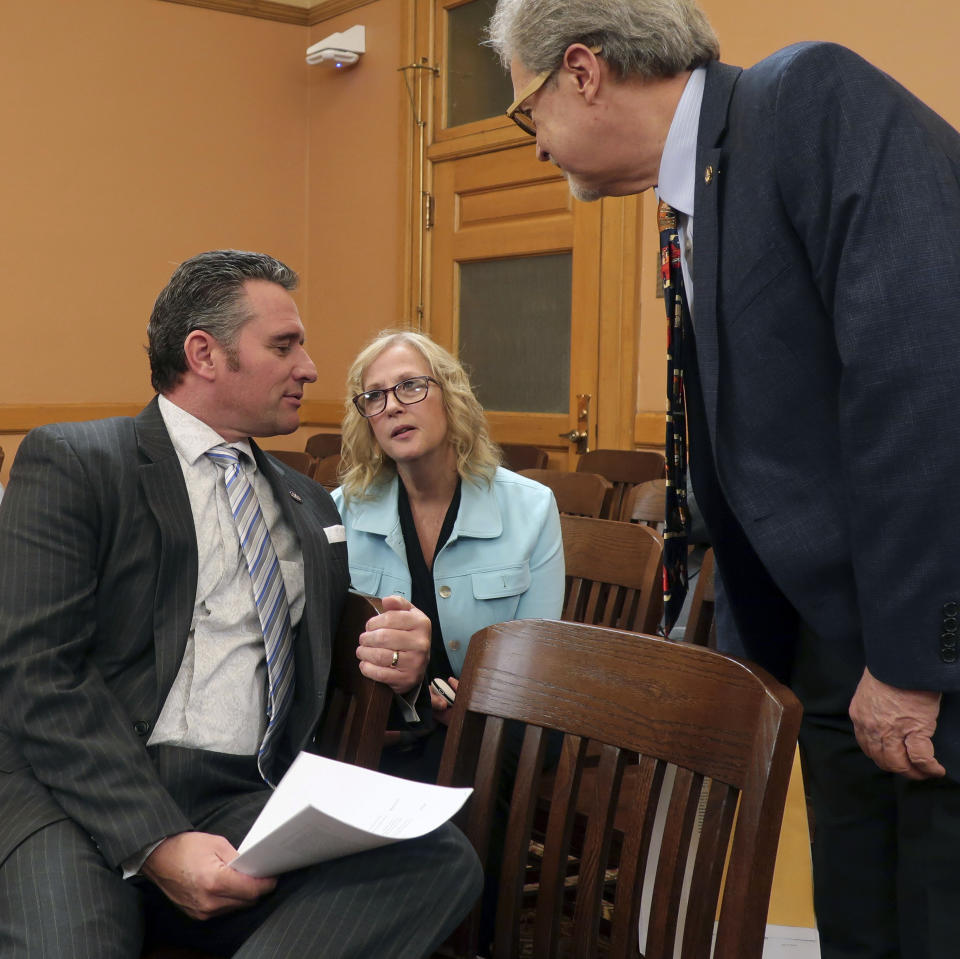 In this Wednesday, Feb. 13, 2019 photo, Kansas state Sens. Ty Masterson, left to right, R-Andover; Mary Pilcher-Cook, R-Shawnee; and Eric Rucker, R-Topeka; confer following a meeting of GOP senators at the Statehouse in Topeka, Kan. All three are abortion opponents and sponsors of a resolution condemning New York's new abortion law. (AP Photo/John Hanna)