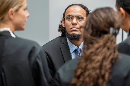 Ahmad al-Faqi al-Mahdi (C) appears at the International Criminal Court in The Hague, Netherlands, August 22, 2016 at the start of his trial on charges of involvement in the destruction of historic mausoleums in Timbuktu during Mali's 2012 conflict. REUTERS/Patrick Post/Pool