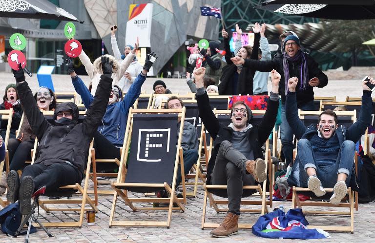 Fans of Australian singer Guy Sebastian who represented his country as a wild card at the 60th Eurovision Song Contest, cheer during a live broadcast to Federation Square in Melbourne, on May 24, 2015