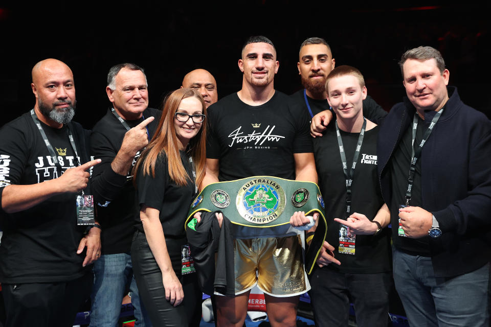 Justis Huni, pictured here with his team after winning the Australian heavyweight title fight against Paul Gallen in 2021.