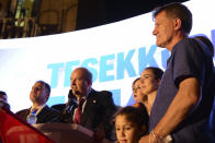 The newly elected Turkish Cypriot leader Ersin Tatar talks to his supporters after winning the Turkish Cypriots election in the Turkish occupied area in the north part of the divided capital Nicosia, Cyprus, Sunday, Oct. 18, 2020. Ersin Tatar, a hardliner who favors even closer ties with Turkey and a tougher stance with rival Greek Cypriots in peace talks has defeated the leftist incumbent in the Turkish Cypriot leadership runoff. (AP Photo/Nedim Enginsoy)