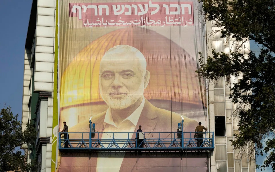 A huge banner is installed in central Tehran showing a portrait of Hamas leader Ismail Haniyeh with the words: 'Wait for severe punishment'