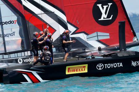 Sailing - America's Cup finals - Hamilton, Bermuda - June 26, 2017 - Peter Burling, Emirates Team New Zealand Helmsman celebrates with his team after defeating Oracle Team USA in race nine to win the America's Cup. REUTERS/Mike Segar