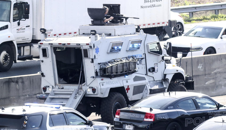 Marietta Police block southbound lanes on Interstate-75, near Marietta, Ga., North of Atlanta, Friday, March 29, 2019. Marietta police said in a brief statement that the southbound lanes of Interstate 75 were shut down Friday morning due to a armed motorist stopped on the freeway just northwest of Atlanta. Police described the motorist as a "non-compliant driver." (John Spink/Atlanta Journal and Constitution via AP)