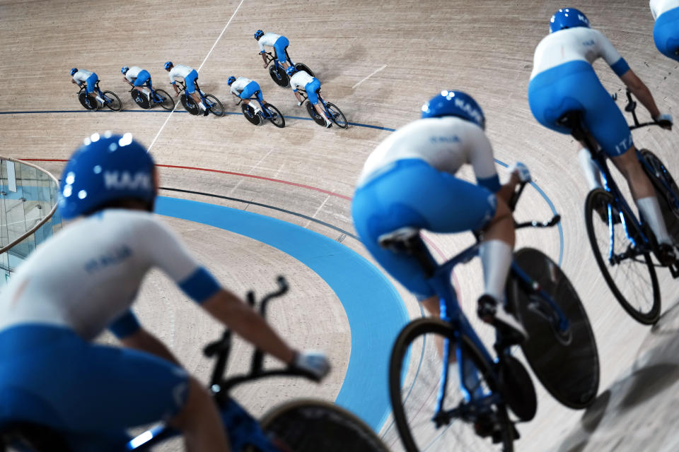 Members of the Italian women's and men's track cycling team round the track during a training session inside the Izu velodrome at the 2020 Summer Olympics, Thursday, July 29, 2021, in Tokyo, Japan. (AP Photo/Thibault Camus)