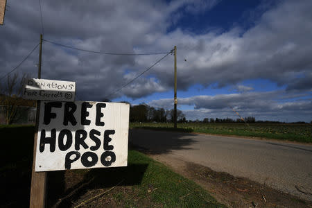 A sign advertising free horse poo stands at the side of a road outside a farm near Boston, Britain March 4, 2019. REUTERS/Clodagh Kilcoyne