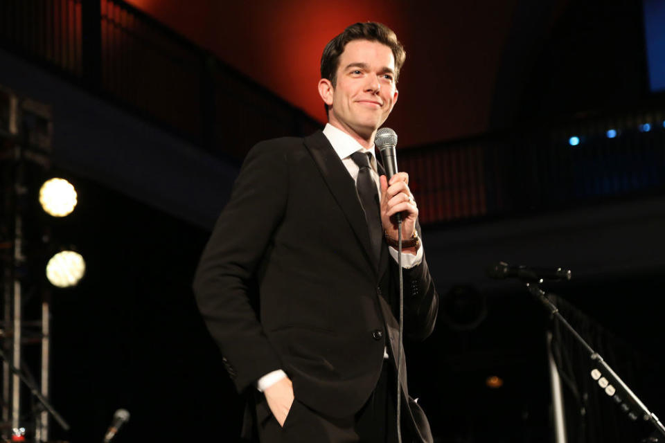 John Mulaney doing stand-up at an event