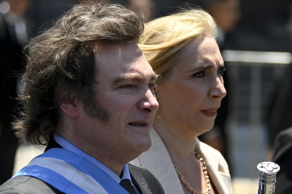 Argentina's newly sworn-in President Javier Milei, left, and his sister Karina arrive to the government house in Buenos Aires, Argentina, Sunday, Dec. 10, 2023. Milei's administration announced two days later economic shock measures aimed at tackling the country's severe crisis, including a sharp devaluation of the peso by 50%, cuts to subsidies and the closure of some ministries. (AP Photo/Julian Bongiovanni)