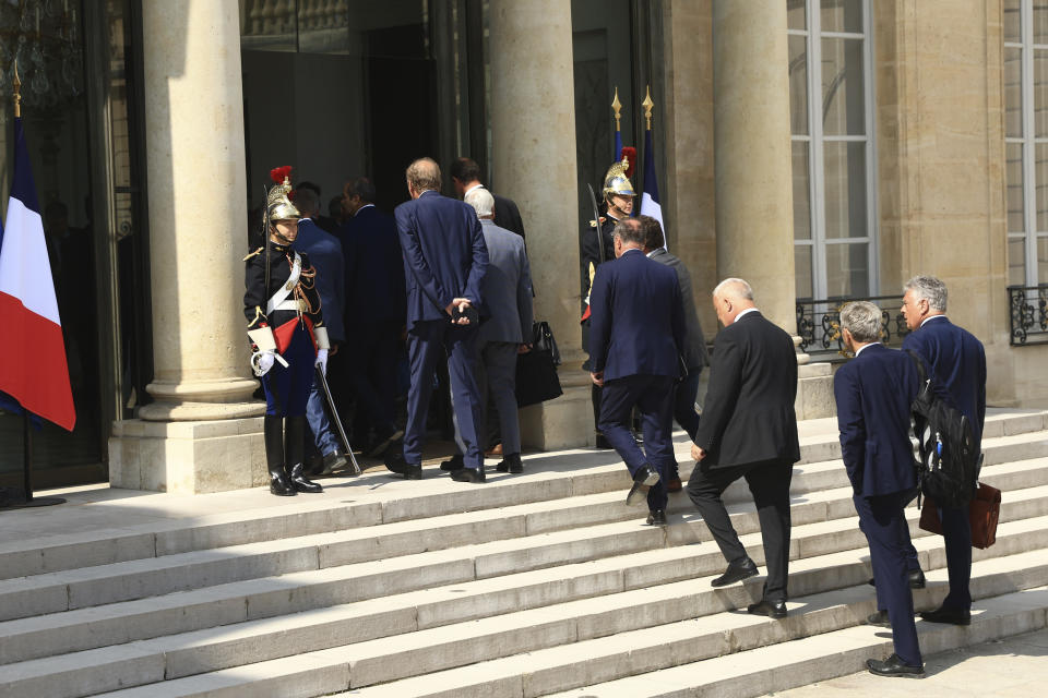 Mayors enter the Elysee Palace Tuesday, July 4, 2023 in Paris. After the death of a 17-year-old shot by police in a Paris suburb, French President Emmanuel Macron was meeting Tuesday with mayors of 220 towns from across the country which were hit by violence. Across France, 34 buildings — many of them linked to the government — were attacked from Sunday into Monday, along with 297 vehicles. (AP Photo/Aurelien Morissard)