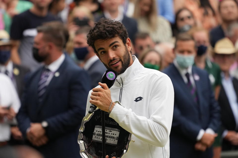 Italy's Matteo Berrettini holds his runners-up trophy and speaks after the men's singles final match against Serbia's Novak Djokovic on day thirteen of the Wimbledon Tennis Championships in London, Sunday, July 11, 2021. (AP Photo/Alberto Pezzali)