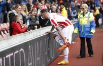 <p>Stoke City’s Marko Arnautovic gives his boots to a young fan after the game </p>