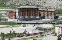 A train of the Gotthard Andermatt Bahnen railways operator stands in front of the Andermatt Swiss Alps resort in Andermatt,