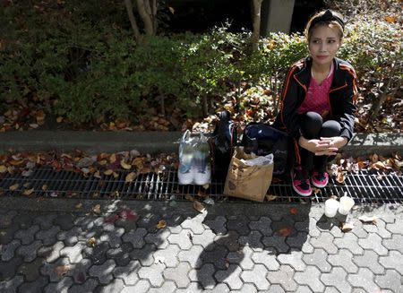 Haruka Rong, a former Cambodian refugee who came to Japan 30 years ago, rests after having lunch with her family during Asia Sports Festa in Yokohama, south of Tokyo, Japan, October 25, 2015. Picture taken October 25, 2015. REUTERS/Yuya Shino