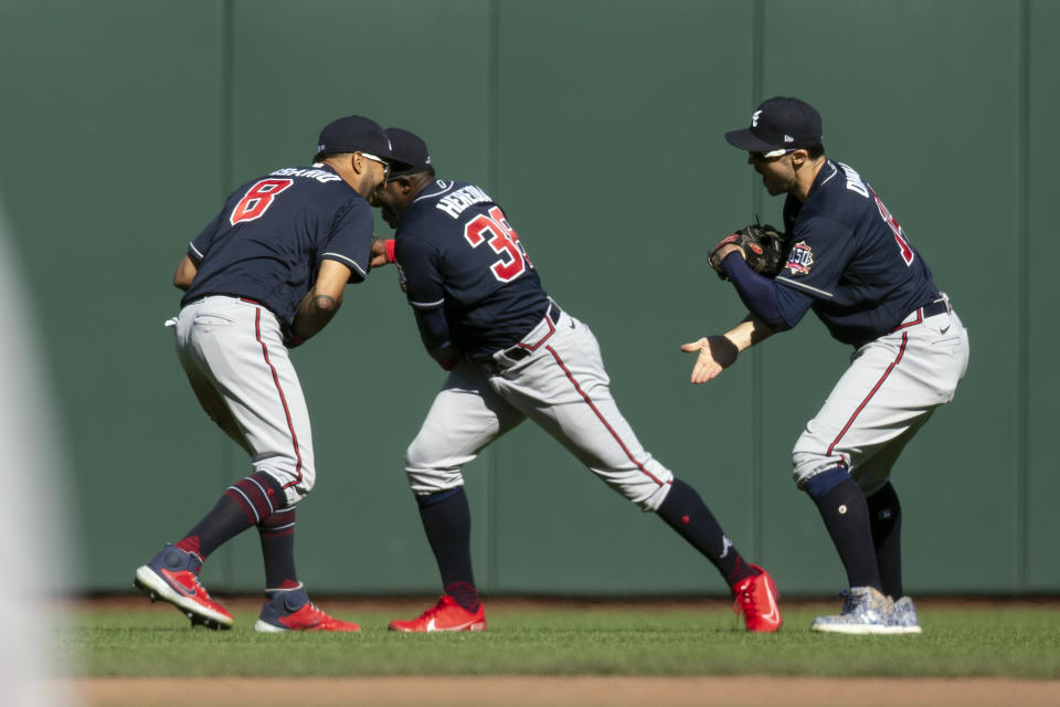 Atlanta Braves outfielders Eddie Rosario (8), Guillermo Heredia (38) and Adam Duvall celebrate their victory over the San Francisco Giants in a baseball game, Sunday, Sept. 19, 2021, in San Francisco. (AP Photo/D. Ross Cameron)