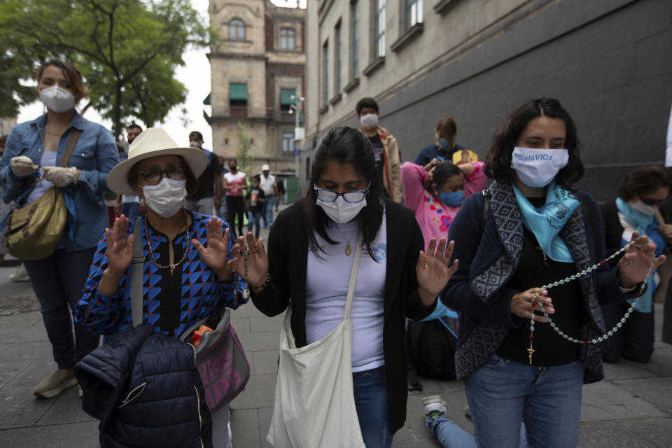 Activists against abortion pray outside the Supreme Court to celebrate the court's decision against an injunction in Veracruz state that aimed to decriminalize abortion for all cases within the first 12 weeks of pregnancy, in Mexico City, Wednesday, July 29, 2020. Two of Mexico’s 32 states have decriminalized abortion. (AP Photo/Fernando Llano)