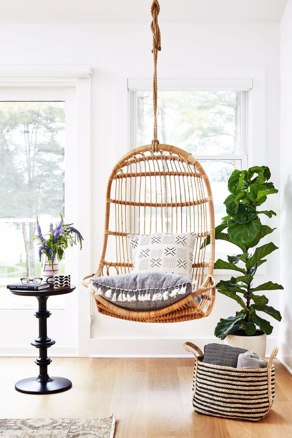 <p>Ideal for a small space, a rattan swing chair and petite end table make for the perfect lounge area. </p>