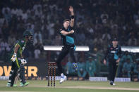 CORRECTS IDENTIFICATION TO BEN SEARS FROM WILL O'ROURKE - Ben Sears, center, bowls as Pakistan's Saim Ayub, left, watches during the fourth T20 international cricket match between Pakistan and New Zealand, in Lahore, Pakistan, Thursday, April 25, 2024. (AP Photo/K.M. Chaudary)