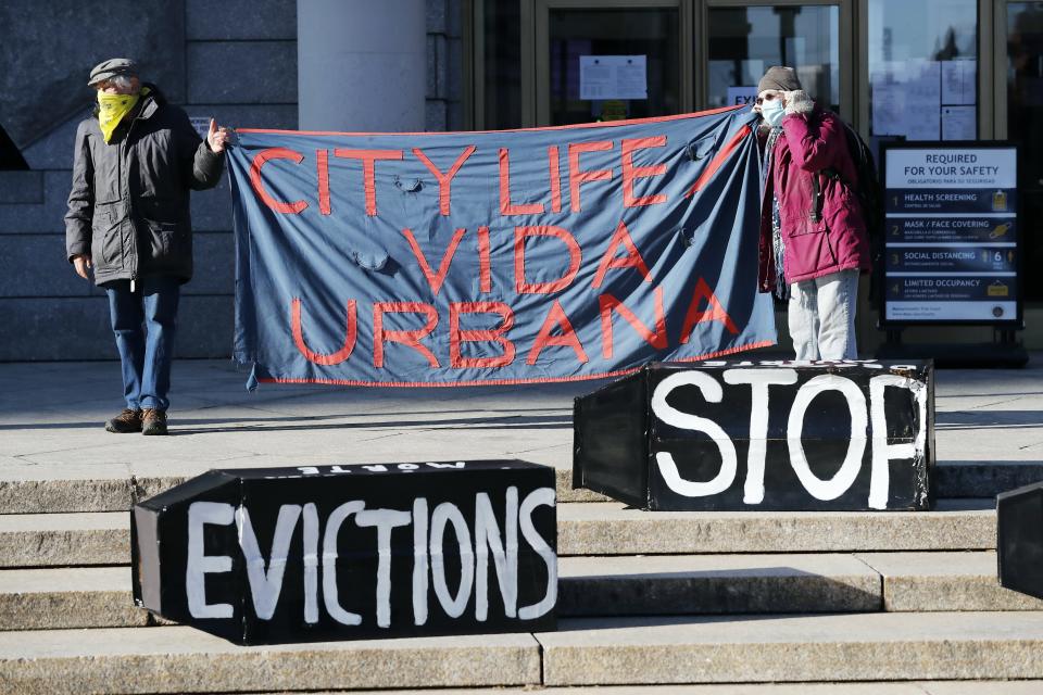 FILE - In this Jan. 13, 2021, file photo, tenants' rights advocates demonstrate in front of the Edward W. Brooke Courthouse in Boston. The Biden administration is extending a federal moratorium on evictions of tenants who've fallen behind on rent during the coronavirus pandemic. The Centers for Disease Control and Prevention on March 29 moved to continue the pandemic-related protection, which had been scheduled to expire on April 1. (AP Photo/Michael Dwyer, File)