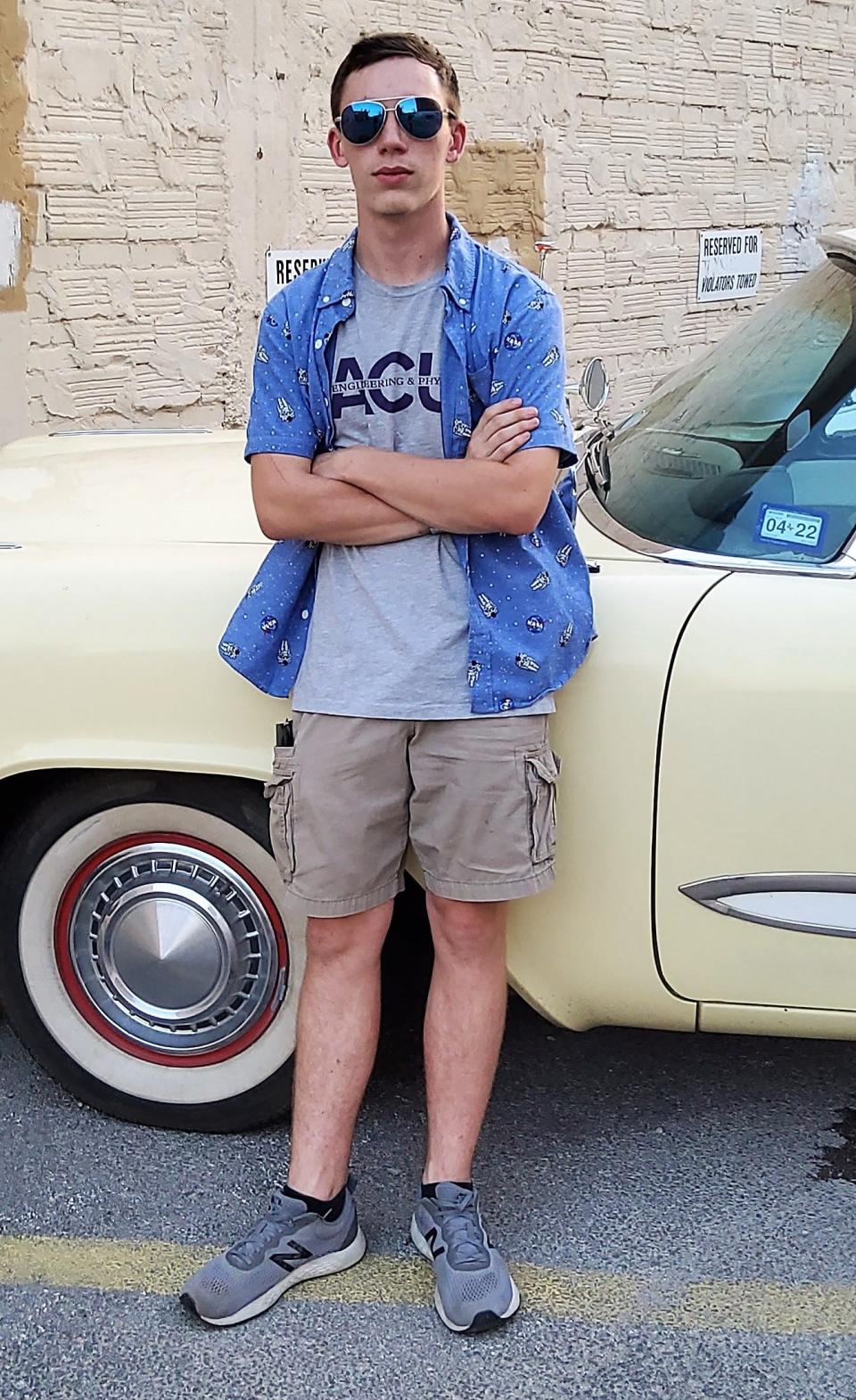 Duncan Lucas, more casually dressed, by another of his vintage cars, a 1958 Plymouth Plaza.