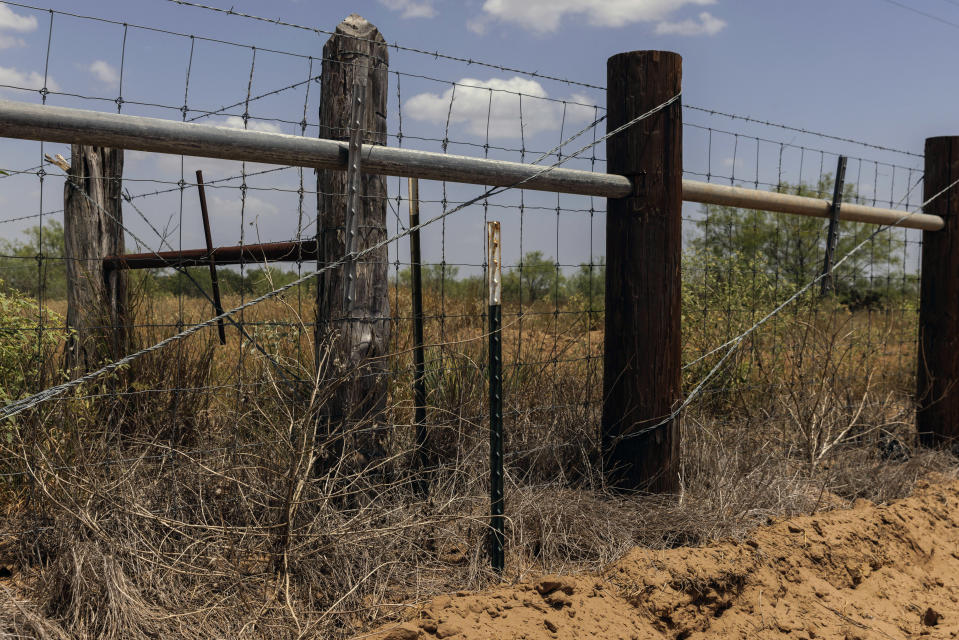 The location of a missing water station for immigrants containing sealed jugs of fresh water is seen along a new portion of fence along private property in rural Jim Hogg County, Texas, Tuesday, July 25, 2023. The South Texas Human Rights Center maintains over 100 blue barrels consistently stocked with water across rural South Texas to serve as a life-saving measure for immigrants who have crossed into the United States to travel north in the sweltering heat. (AP Photo/Michael Gonzalez)