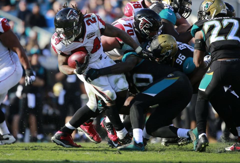 Dec 20, 2015; Jacksonville, FL, USA; Atlanta Falcons running back Devonta Freeman (24) runs with the ball against the Jacksonville Jaguars during the second half at EverBank Field. Atlanta Falcons defeated the Jacksonville Jaguars 23-17. Mandatory Credit: Kim Klement-USA TODAY Sports