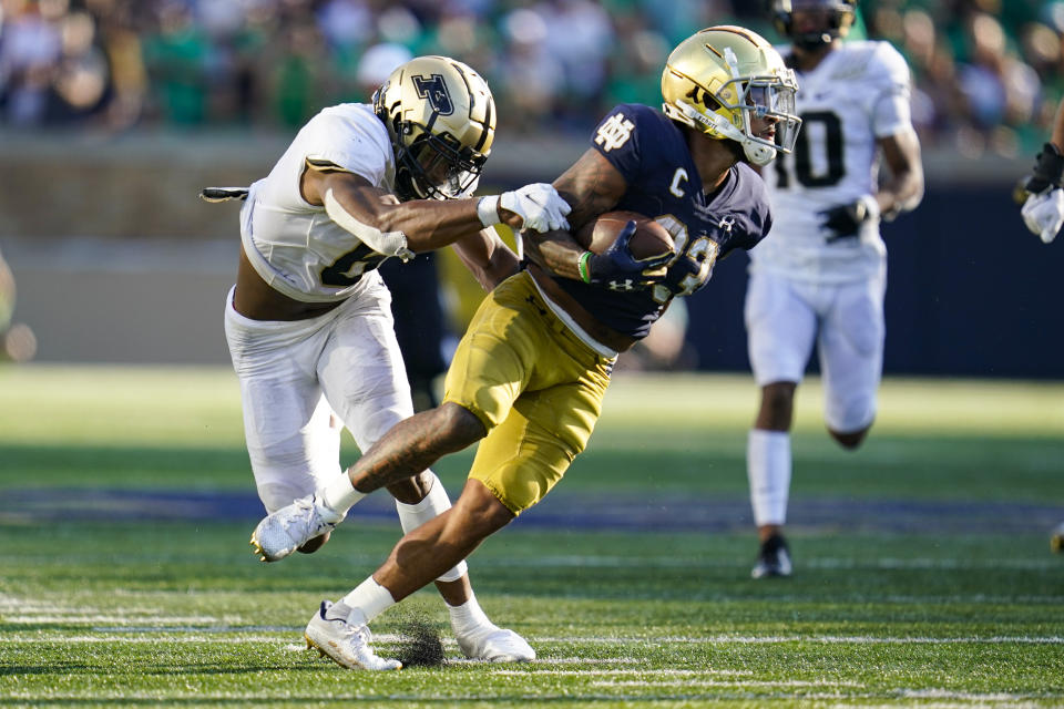 Notre Dame running back Kyren Williams (23) breaks the tackle of Purdue linebacker Jalen Graham (6) on his way to a touchdown during the second half of an NCAA college football game in South Bend, Ind., Saturday, Sept. 18, 2021. Notre Dame defeated Purdue 27-13. (AP Photo/Michael Conroy)
