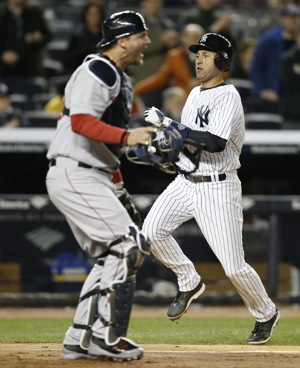 Boston Red Sox catcher A.J. Pierzynski, left, reacts as New York Yankees' Derek Jeter scores on Jacoby Ellsbury's fifth-inning RBI-single in a baseball game at Yankee Stadium in New York, Thursday, April 10, 2014. The Yankees defeated the Red Sox 4-1. (AP Photo/Kathy Willens)