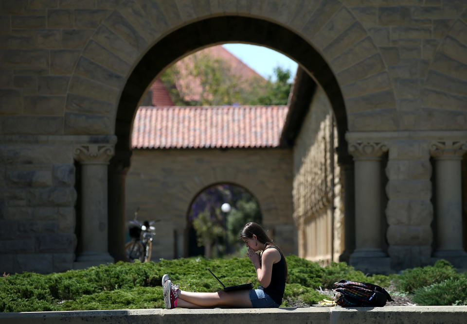 STANFORD, CA - MAY 22: A woman works on a laptop on the Stanford University campus on May 22, 2014 in Stanford, California. According to the Academic Ranking of World Universities by China's Shanghai Jiao Tong University, Stanford University ranked second behind Harvard University as the top universities in the world. UC Berkeley ranked third. (Photo by Justin Sullivan/Getty Images)