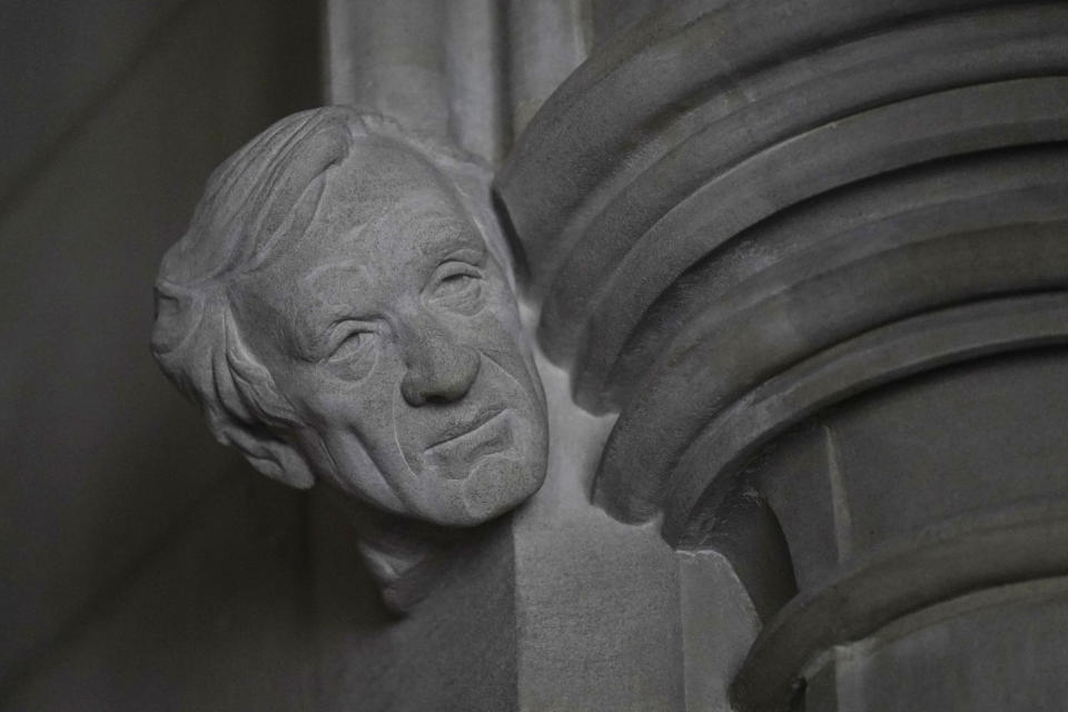 A limestone head of Holocaust survivor and Nobel Peace Prize winning author Elie Wiesel, carved by Sean Callahan from a clay sculpture by artist Chas Fagan, is almost complete in the Human Rights Porch of the Washington National Cathedral, Friday, April 16, 2021. Wiesel, who died in 2016, was the author of 57 books including “Night,” which is based on his experiences as a Jewish prisoner in the Auschwitz and Buchenwald concentration camps. He became an outspoken advocate for human rights causes around the world, helped found the United States Holocaust Memorial Museum and was awarded the Nobel Peace Prize in 1986. (AP Photo/Carolyn Kaster)