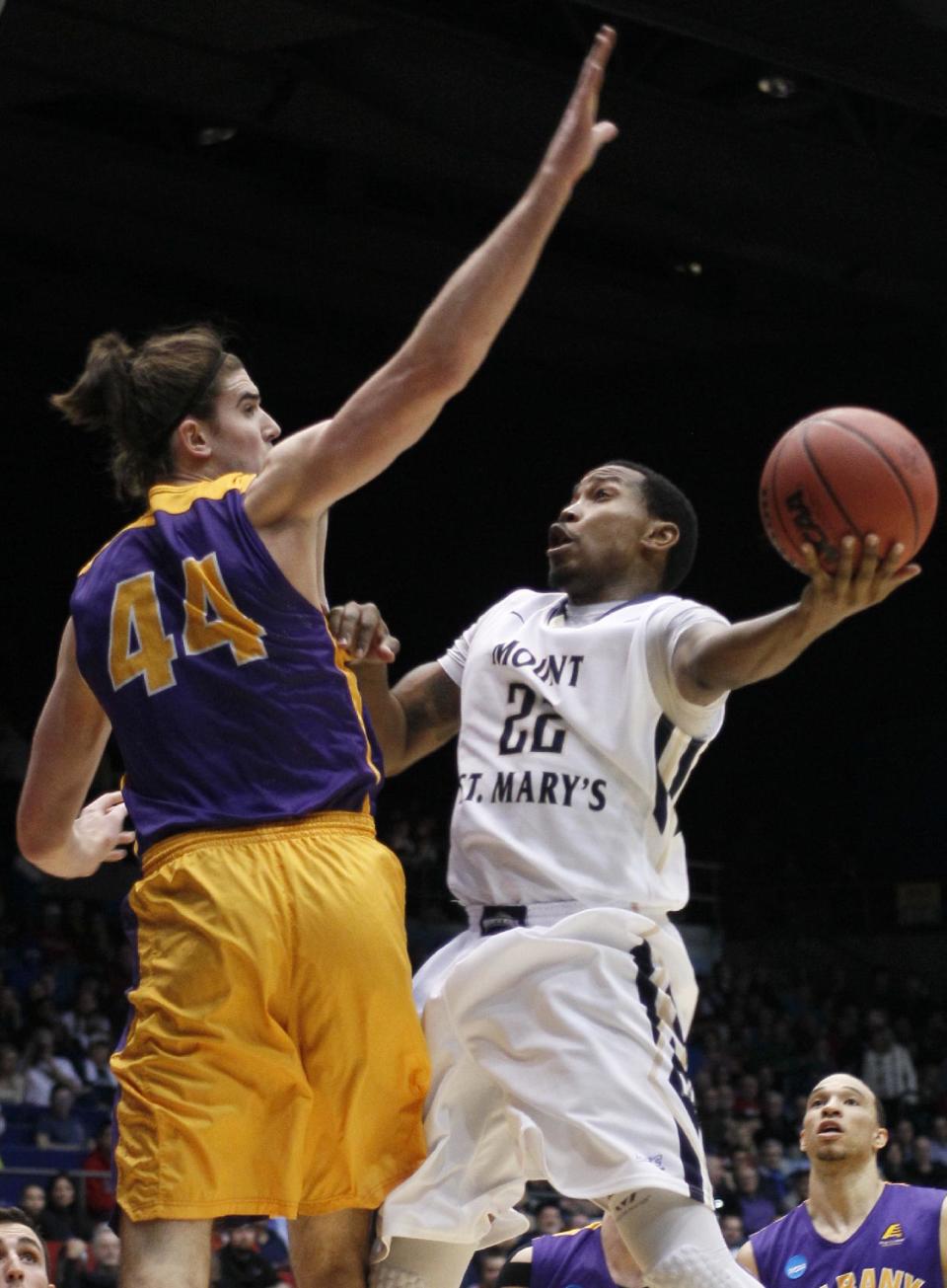 Mount St. Mary's guard Rashad Whack (22) drives against Albany center John Puk (44) during the first half of a first-round game of the NCAA college basketball tournament, Tuesday, March 18, 2014, in Dayton, Ohio. (AP Photo/Skip Peterson)