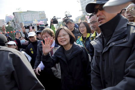 Taiwan's Democratic Progressive Party (DPP) Chairperson and presidential candidate Tsai Ing-wen greets supporters gathering in front of a temple at the beginning of a campaign rally in Kaohsiung, southern Taiwan January 14, 2016. REUTERS/Damir Sagolj
