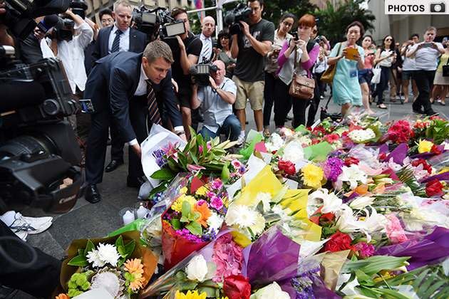 GALLERY: Mike Baird lays flowers in Martin Place. Photo: AAP