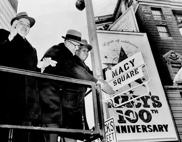 1958 Wheelock Bingham, President of R. H. Macy, Co, Inc., Jack I. Straus, Chairman of the Board and Hulan Jack, Manhattan Boro President, changing a street sign from Herald Square to Macy Square, during the 100th anniversary of Macy's.  (Photo by Fred Morgan/NY Daily News Archive via Getty Images)